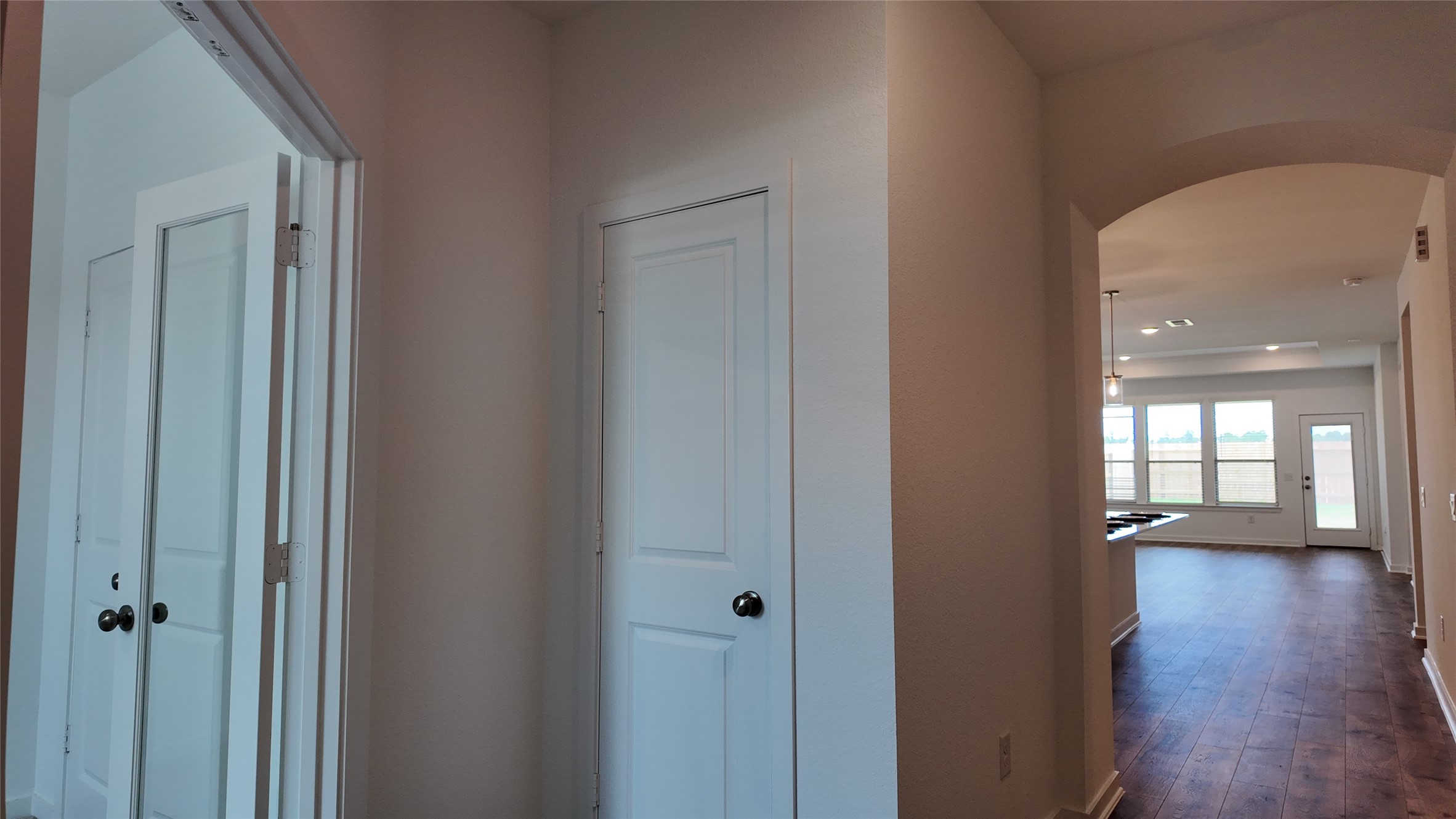 15645 Wandering Maple Way Conroe, TX 77302 - Photo 2 of 14 a view of a hallway view with wooden floor and a living room