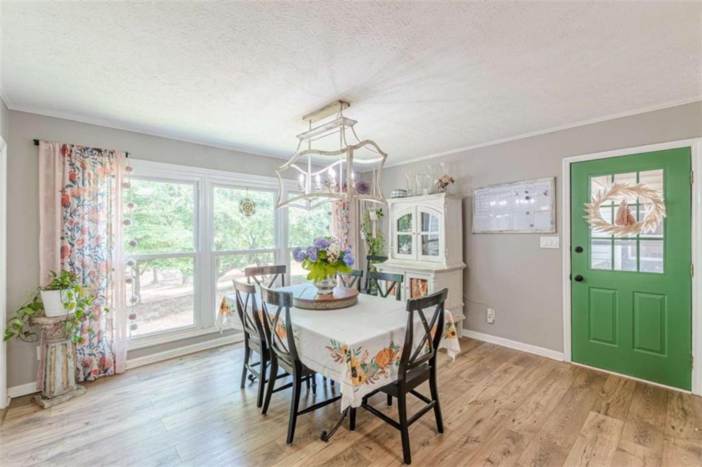 2229 South Van Wert Road Villa Rica, GA 30180 - Photo 15 of 92 a view of a dining room with furniture window and wooden floor