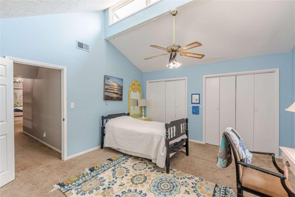 2229 South Van Wert Road Villa Rica, GA 30180 - Photo 27 of 92 a bedroom with a bed and a chandelier