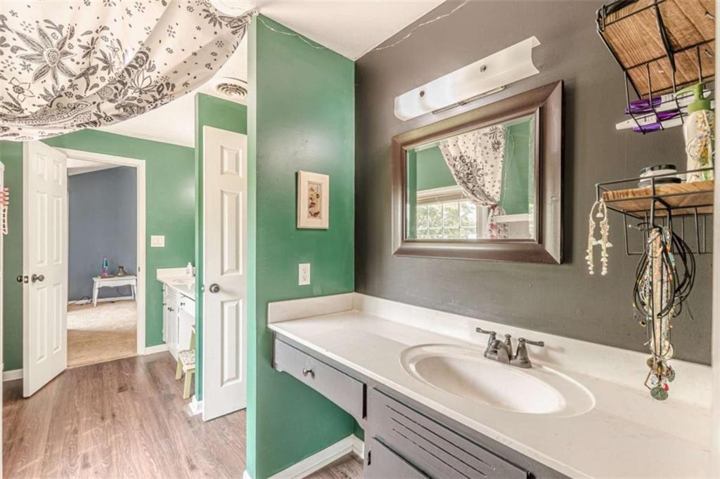 2229 South Van Wert Road Villa Rica, GA 30180 - Photo 36 of 92 a en suite bathroom with a sink mirror and shower