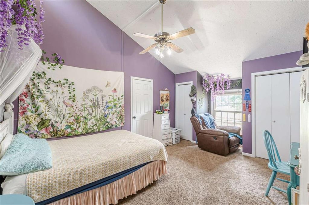 2229 South Van Wert Road Villa Rica, GA 30180 - Photo 38 of 92 a bedroom with a large bed and a chandelier