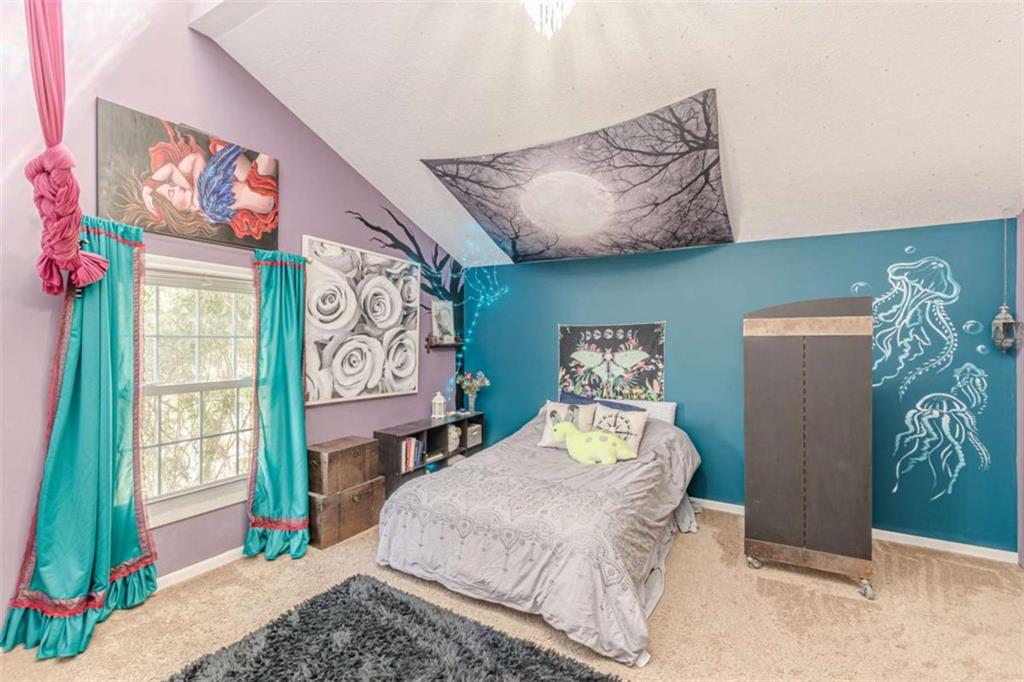 2229 South Van Wert Road Villa Rica, GA 30180 - Photo 40 of 92 a bedroom with a bed and a painting on the wall