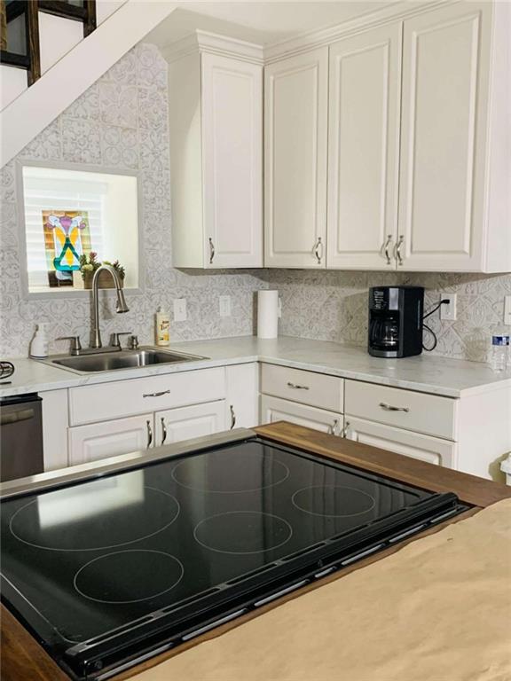2229 South Van Wert Road Villa Rica, GA 30180 - Photo 50 of 92 a kitchen with granite countertop a sink and white cabinets
