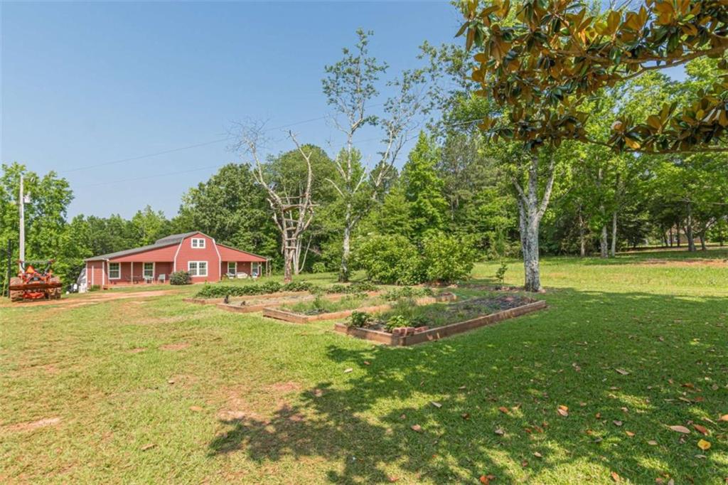 2229 South Van Wert Road Villa Rica, GA 30180 - Photo 66 of 92 a backyard of a house with lots of green space and fountain