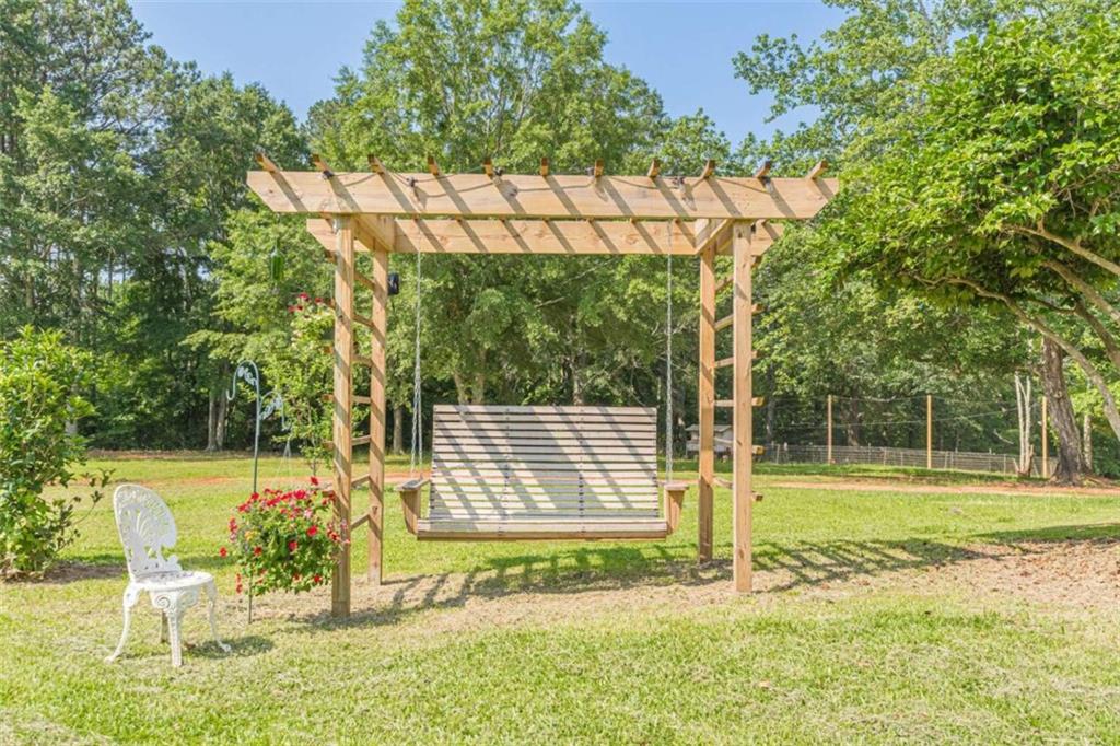 2229 South Van Wert Road Villa Rica, GA 30180 - Photo 71 of 92 a view of a porch with a table and chairs under an umbrella