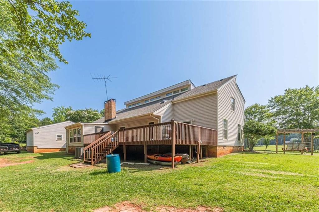 2229 South Van Wert Road Villa Rica, GA 30180 - Photo 81 of 92 a view of a house with a big yard and large trees