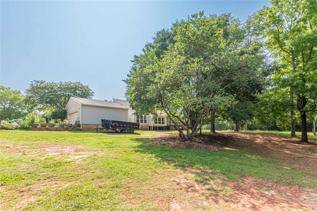 2229 South Van Wert Road Villa Rica, GA 30180 - Photo 83 of 92 a view of a house with a yard and a large tree