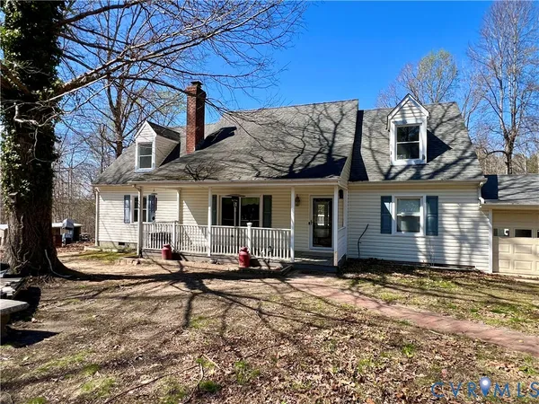 a view of a house with backyard porch and sitting area