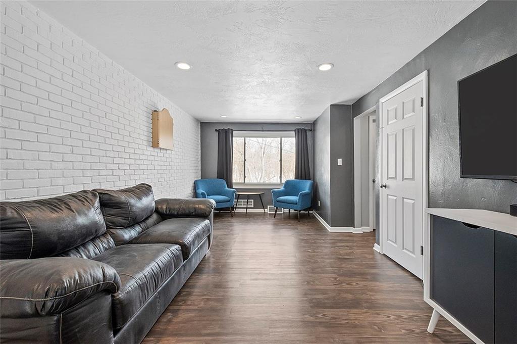 227 Elm Road Pittsburgh, PA 15239 - Photo 11 of 25 a living room with furniture and a flat screen tv
