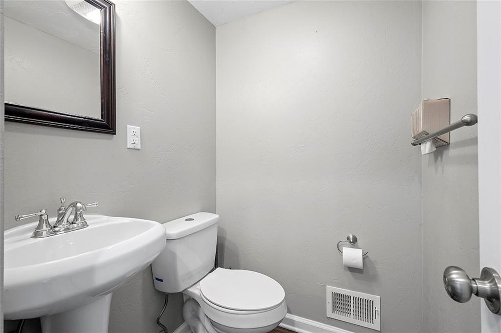 227 Elm Road Pittsburgh, PA 15239 - Photo 12 of 25 a bathroom with a sink a toilet and a mirror