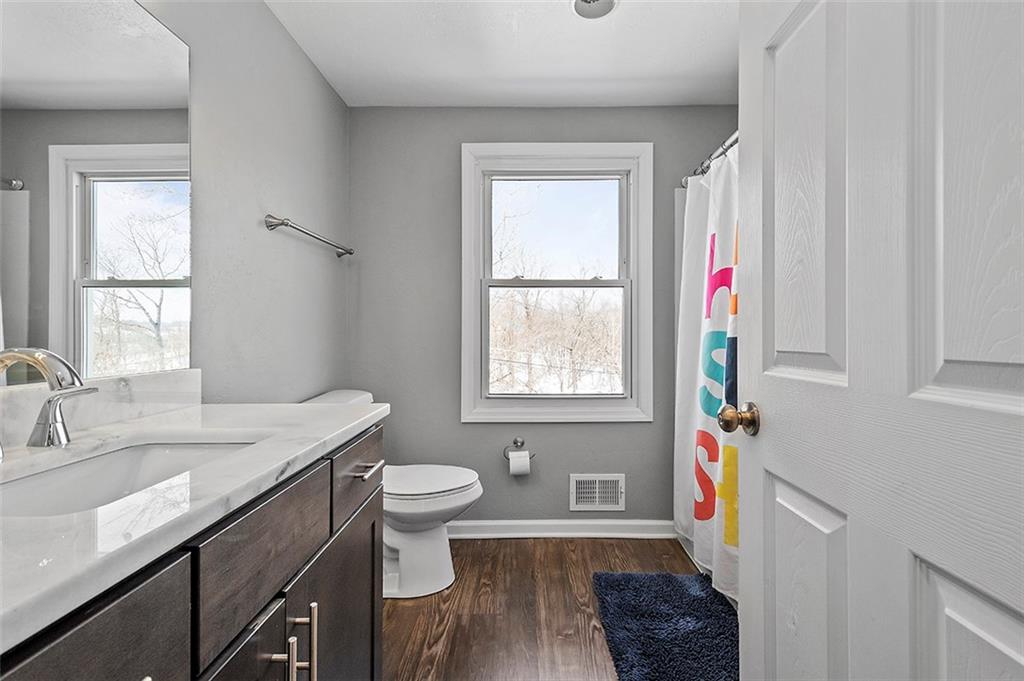 227 Elm Road Pittsburgh, PA 15239 - Photo 14 of 25 a bathroom with a sink a toilet and a window