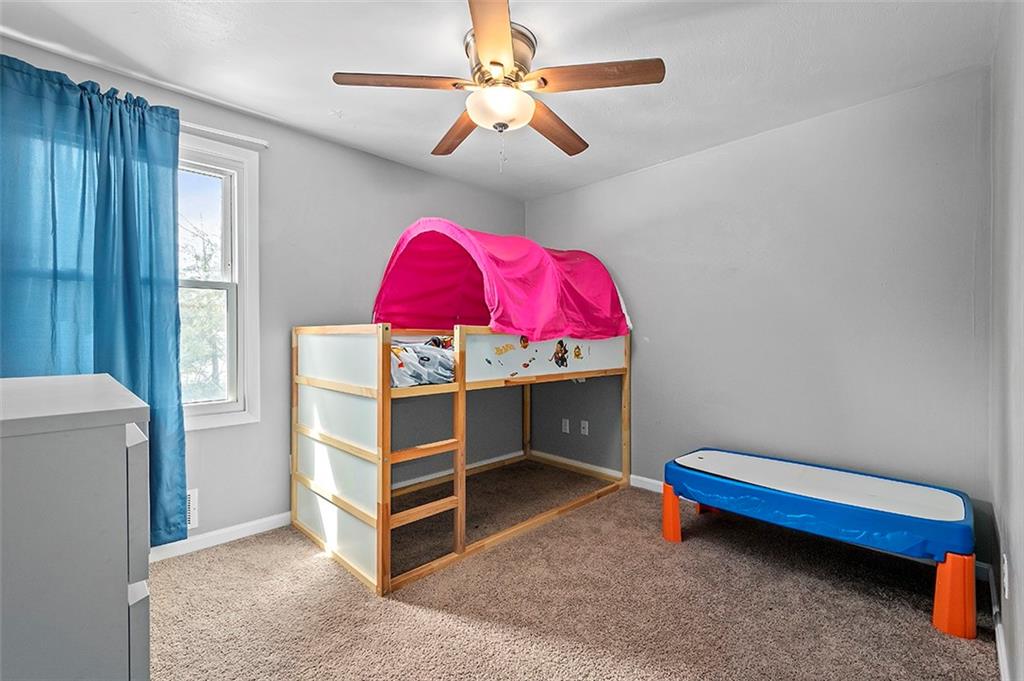 227 Elm Road Pittsburgh, PA 15239 - Photo 17 of 25 a bedroom with a bed and a chandelier