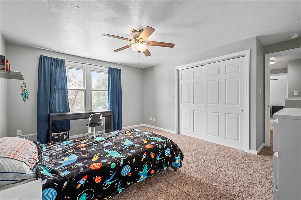 227 Elm Road Pittsburgh, PA 15239 - Photo 18 of 25 a bedroom with a large bed and a window