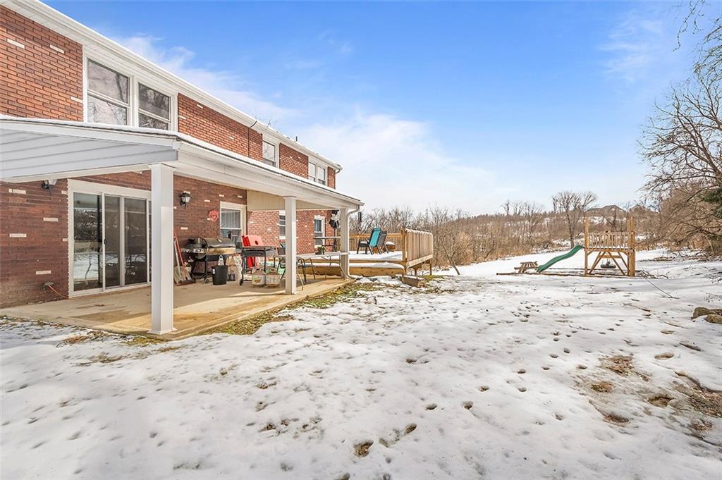 227 Elm Road Pittsburgh, PA 15239 - Photo 23 of 25 a view of a yard with a house in the background
