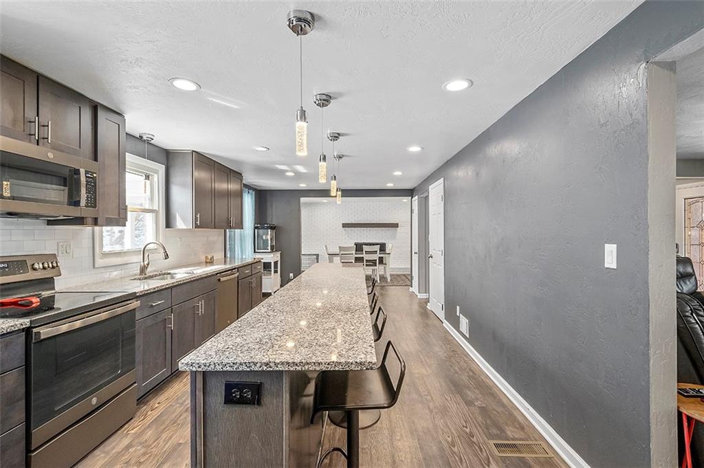 227 Elm Road Pittsburgh, PA 15239 - Photo 3 of 25 a large kitchen with granite countertop lots of counter space and wooden floor