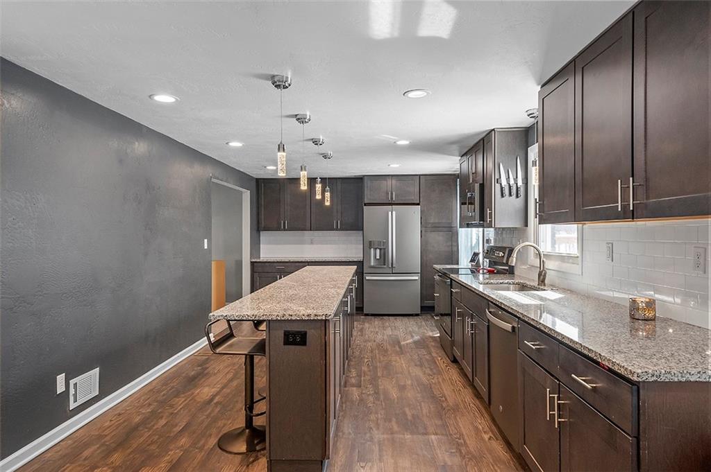 227 Elm Road Pittsburgh, PA 15239 - Photo 5 of 25 a kitchen with granite countertop a sink stove and refrigerator