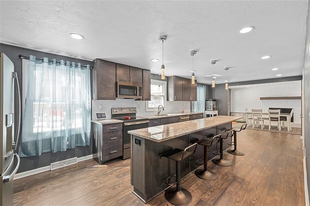 227 Elm Road Pittsburgh, PA 15239 - Photo 6 of 25 a large kitchen with stainless steel appliances lots of counter space and windows