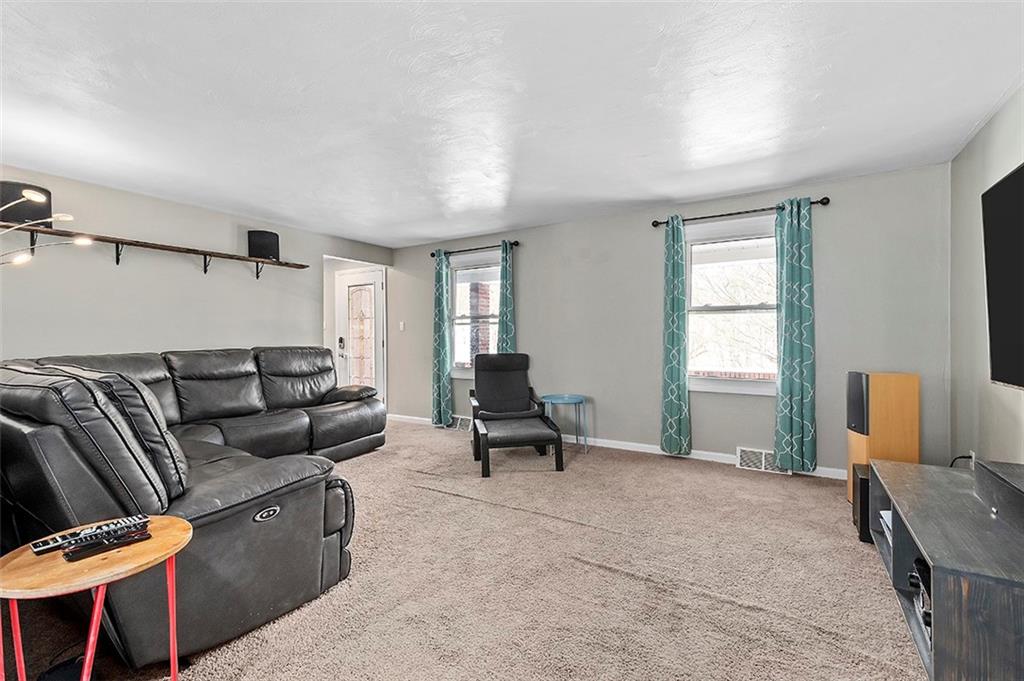 227 Elm Road Pittsburgh, PA 15239 - Photo 10 of 25 a living room with furniture and a window