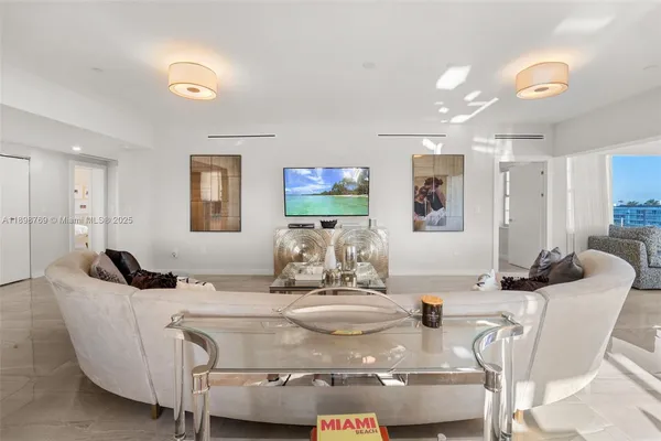 a dining room with furniture and a chandelier