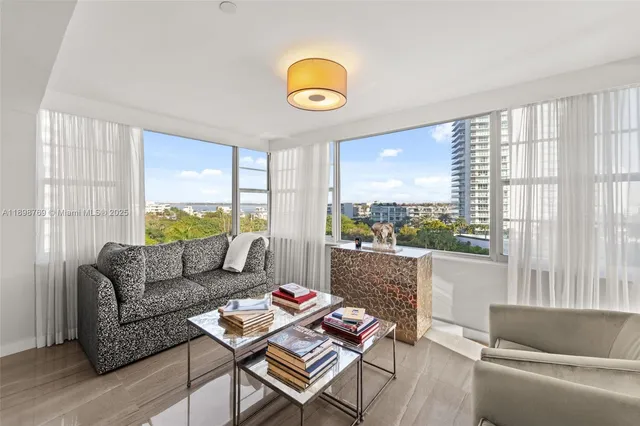 a living room with furniture and a view of kitchen