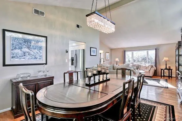 a dining room with furniture a rug and wooden floor