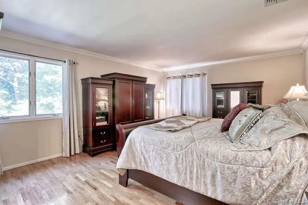 a bedroom with a bed and a large mirror