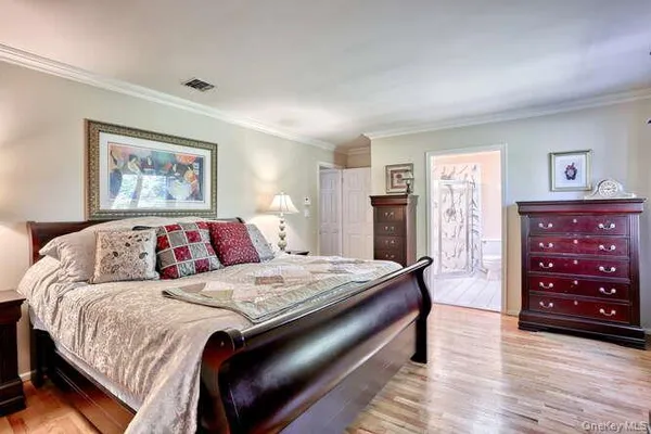 a bedroom with a bed and a dresser