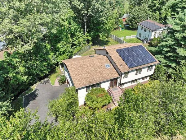 an aerial view of a house with garden space and street view