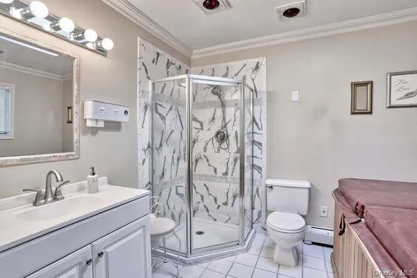 a bathroom with a granite countertop sink a toilet and a shower
