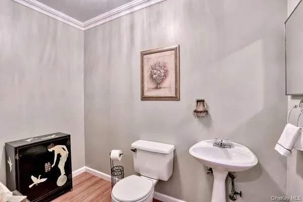 a bathroom with a sink toilet and a mirror