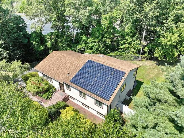 an aerial view of a house with a yard