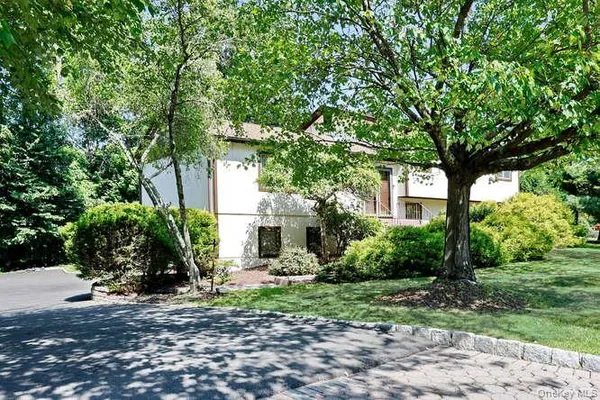 a view of a house with a tree in front