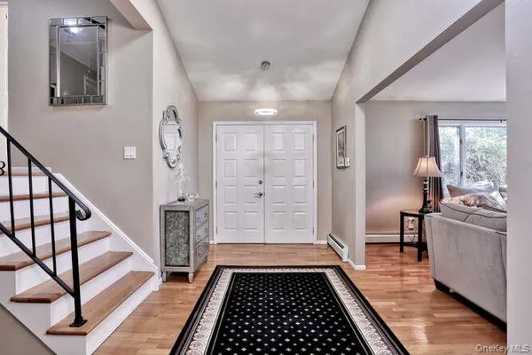 a view of a hallway with wooden floor and staircase