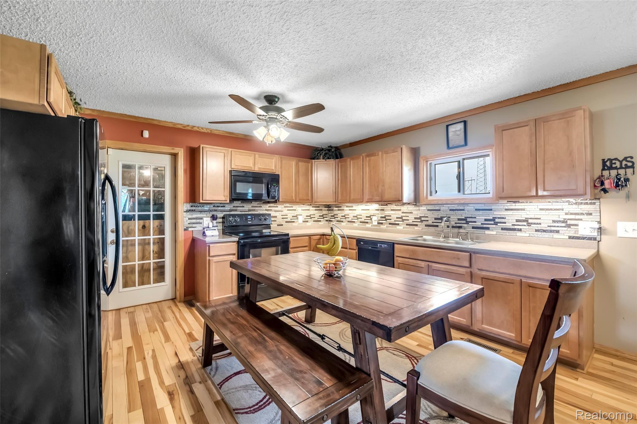 2185 Peet Road New Lothrop, MI 48460 - Photo 6 of 29 Timeless Black Appliances ~ New Tile Backsplash