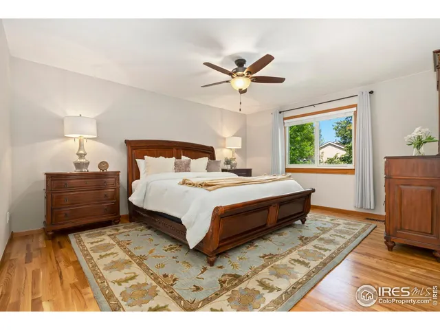 a bedroom with a bed dresser and a window