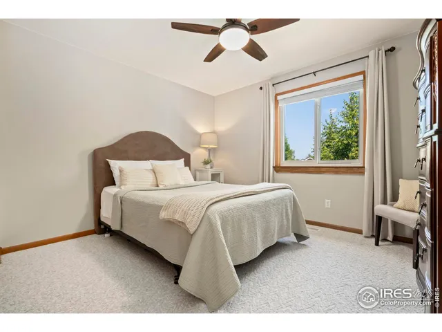 a bedroom with a bed lamps and a large mirror