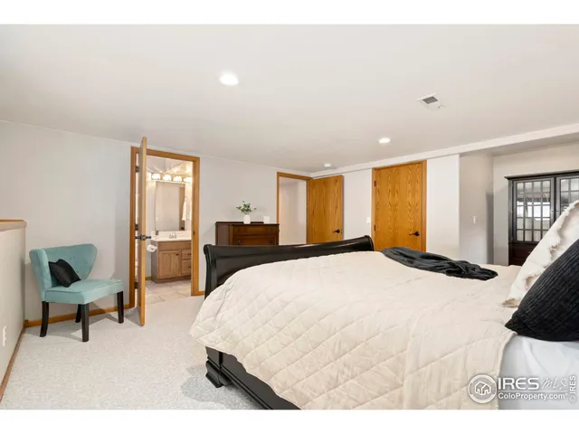 a spacious bedroom with a bed and a large window