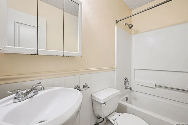 a bathroom with a sink a toilet and bathtub