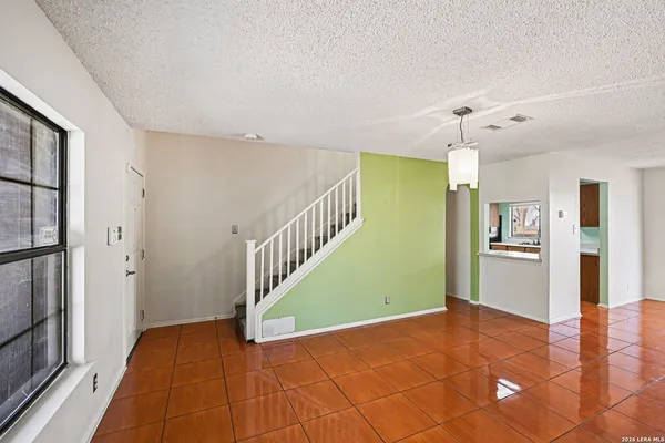 a view of a room with wooden floor and stairs