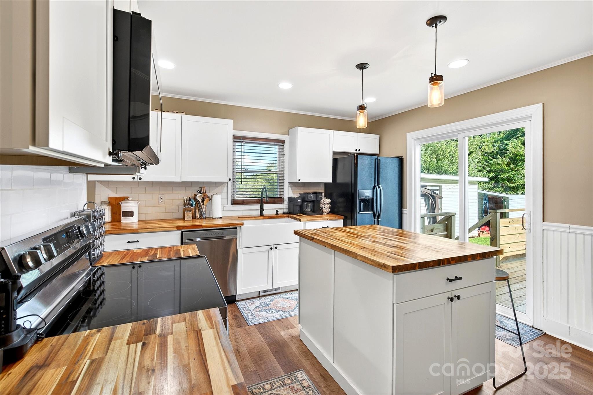 87 2nd Street Marion, NC 28752 - Photo 11 of 31 a kitchen with granite countertop a sink stove and refrigerator