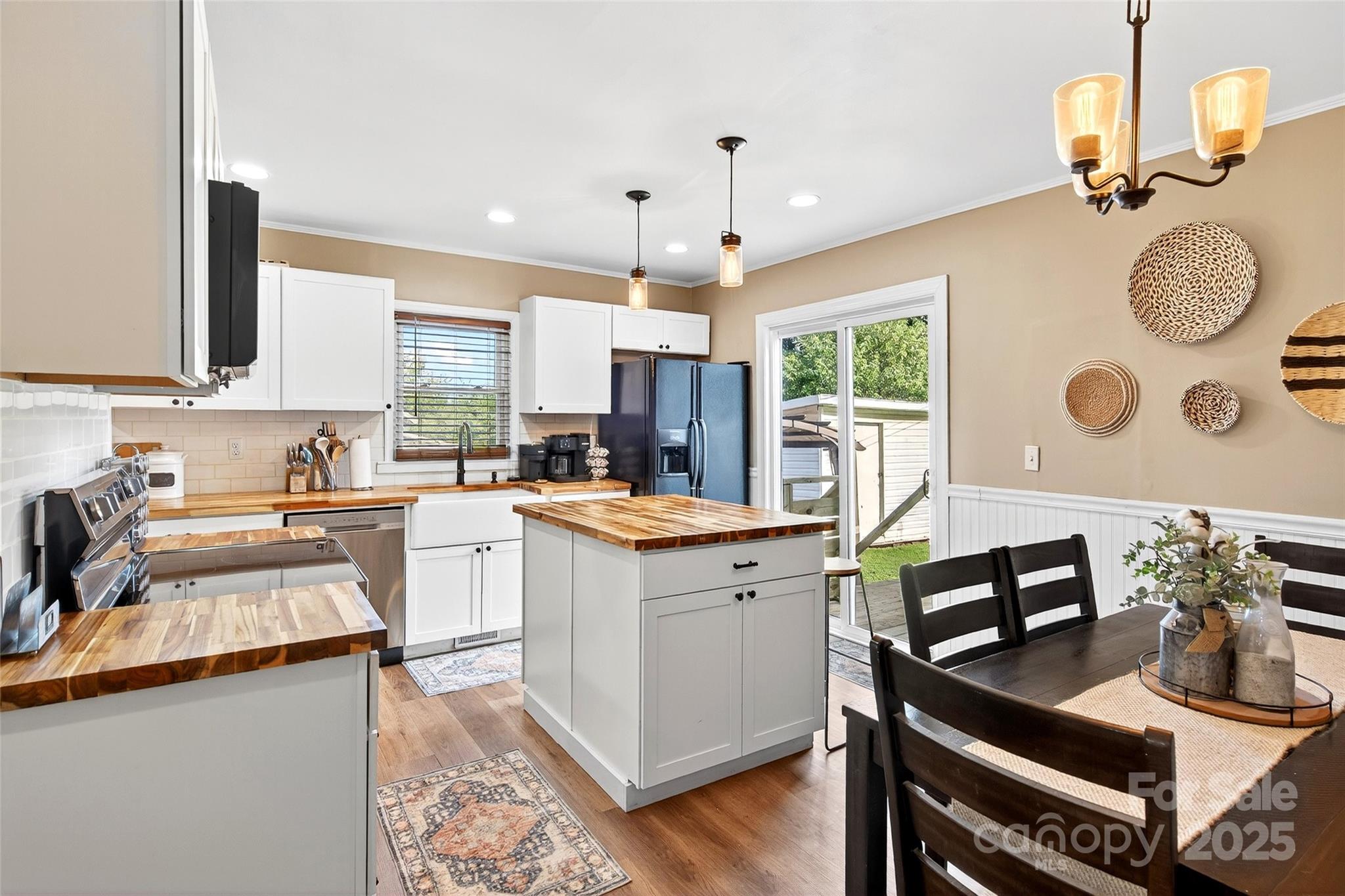 87 2nd Street Marion, NC 28752 - Photo 12 of 31 a kitchen with a refrigerator and a stove top oven