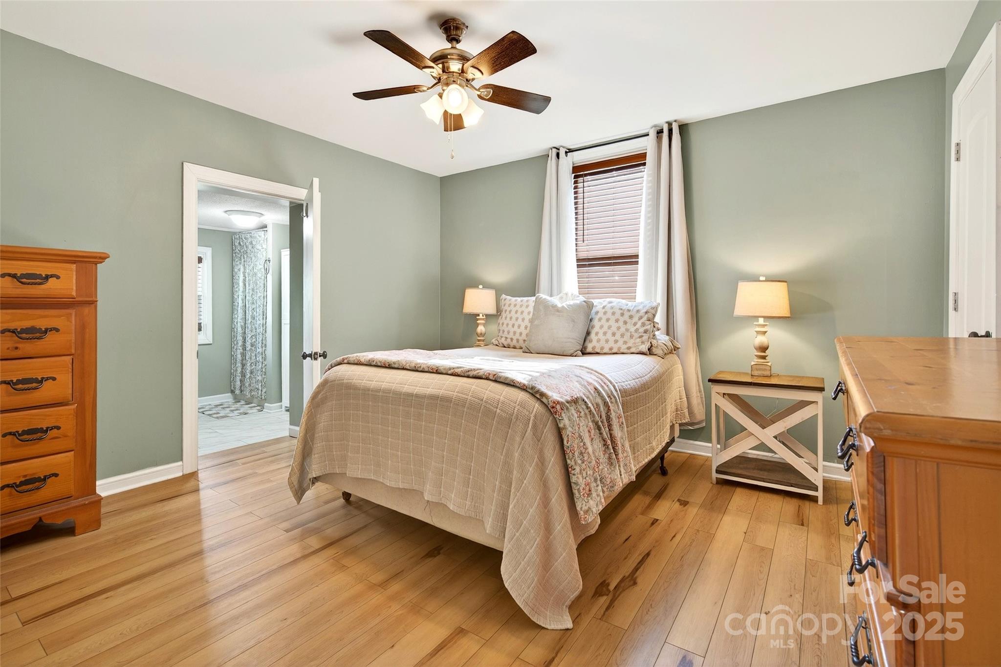 87 2nd Street Marion, NC 28752 - Photo 20 of 31 a bedroom with a bed and a chandelier