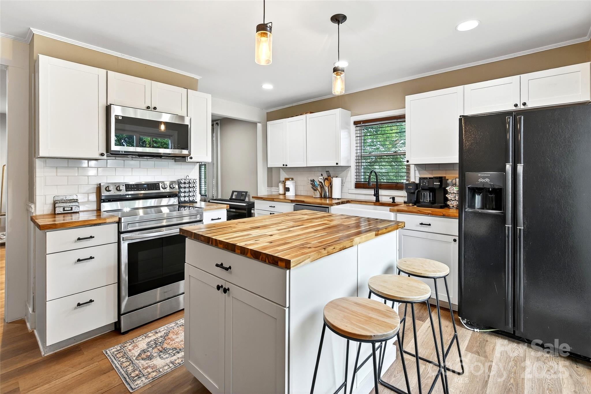 87 2nd Street Marion, NC 28752 - Photo 2 of 31 a kitchen with stainless steel appliances granite countertop a stove refrigerator sink and microwave