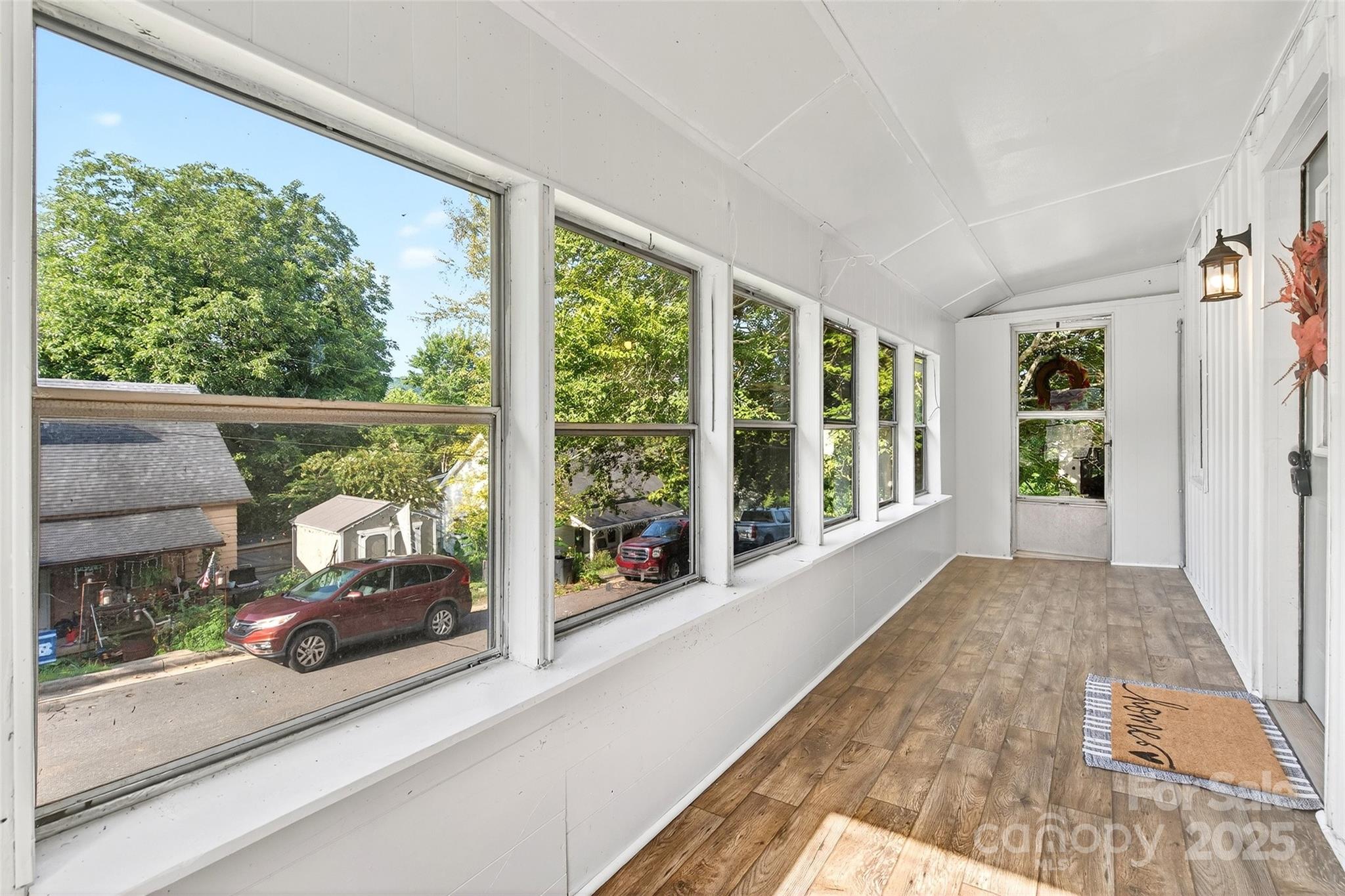 87 2nd Street Marion, NC 28752 - Photo 27 of 31 a view of a balcony with floor to ceiling window with wooden floor