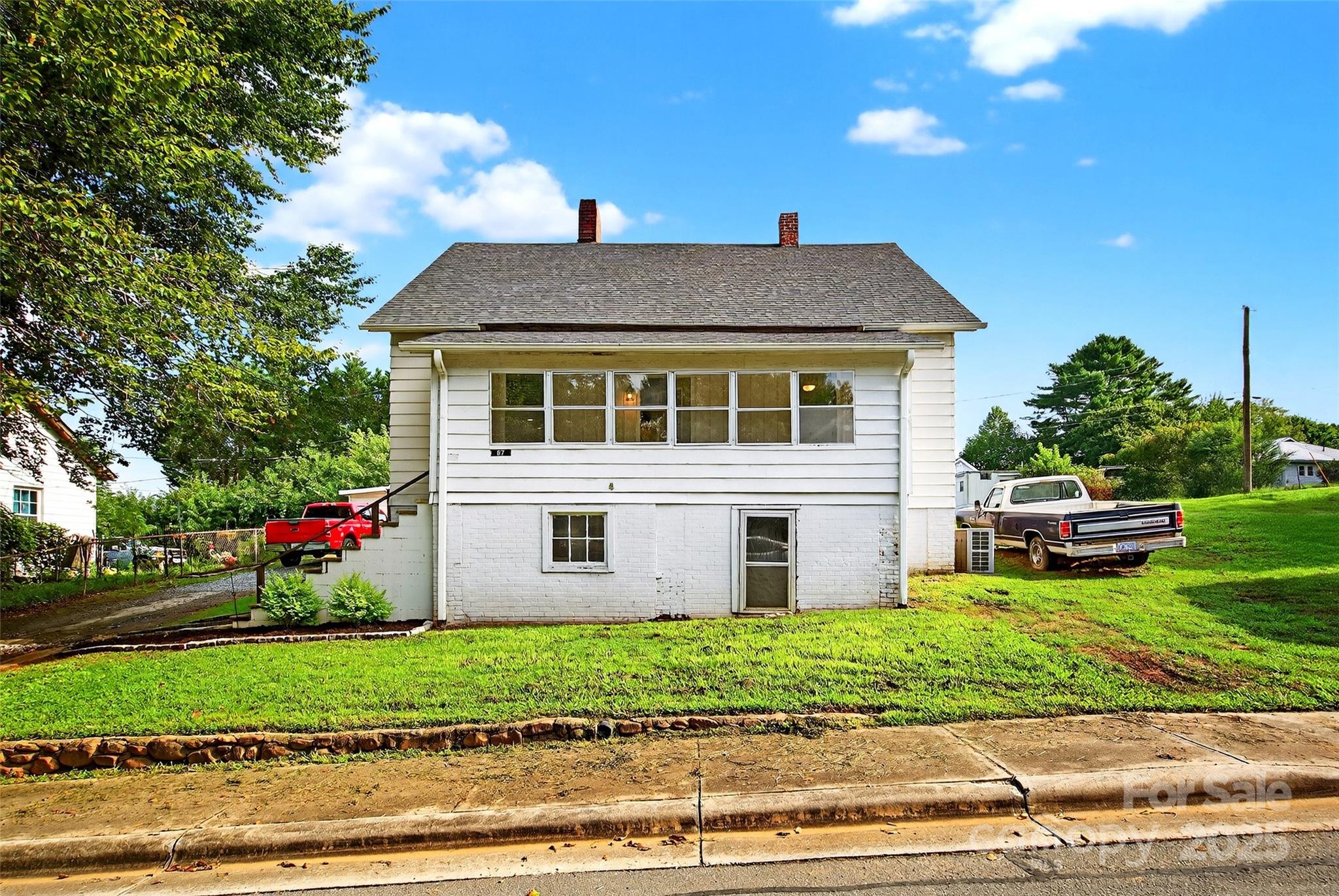 87 2nd Street Marion, NC 28752 - Photo 28 of 31 a front view of a house with a yard and a garage