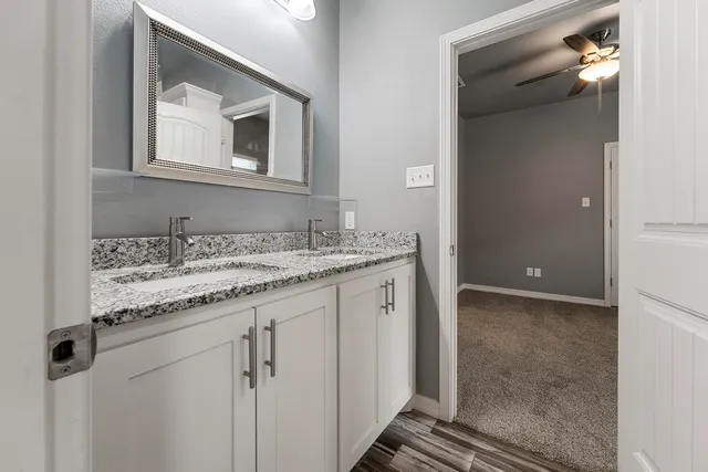 an empty room with closet and a chandelier fan