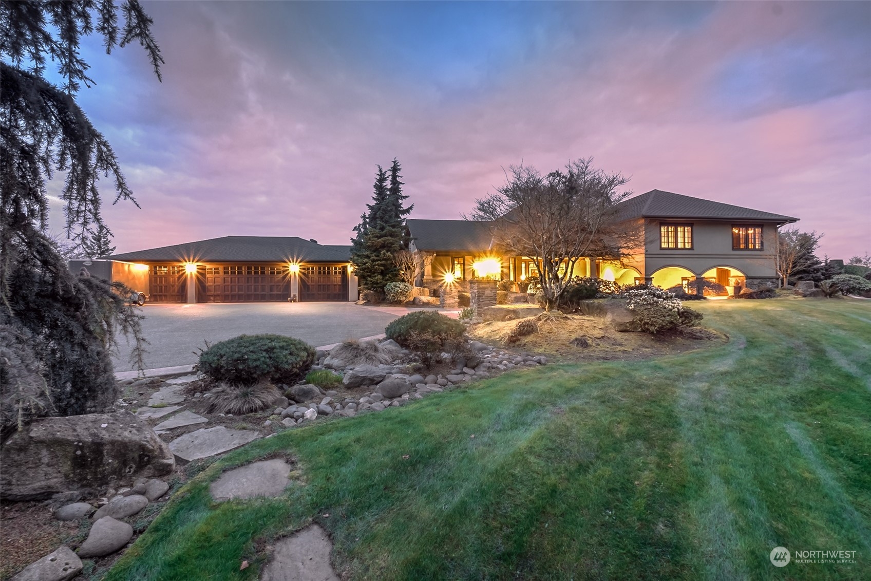 12408 County Line Road East Edgewood, WA 98372 - Photo 1 of 40 a front view of a house with a garden and a yard