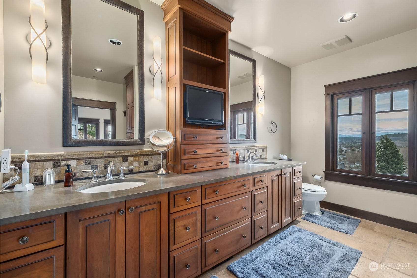 12408 County Line Road East Edgewood, WA 98372 - Photo 19 of 40 a spacious bathroom with a double vanity sink a large mirror and a bathtub