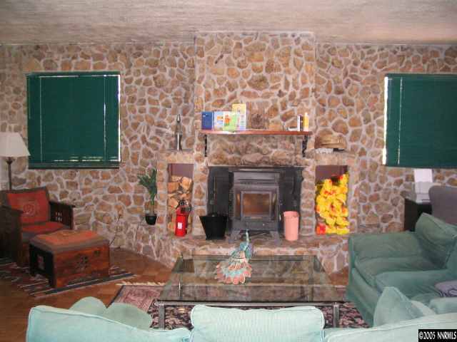 5914 Grass Valley Road Reno, NV 89510 - Photo 4 of 7 a living room with fireplace furniture and a fireplace