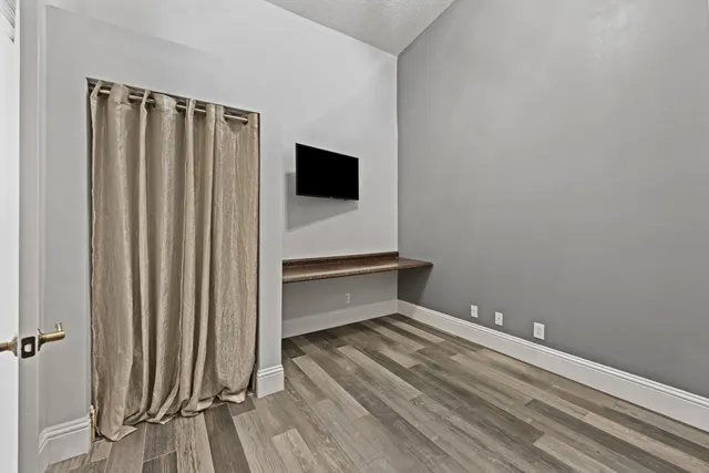 a view of a room with wooden floor and a sink